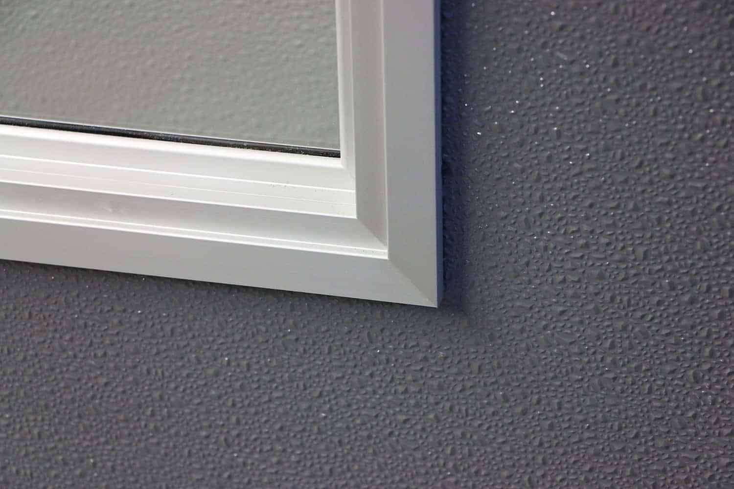 A gray wall enhanced with Muntins, showcasing a white window frame.