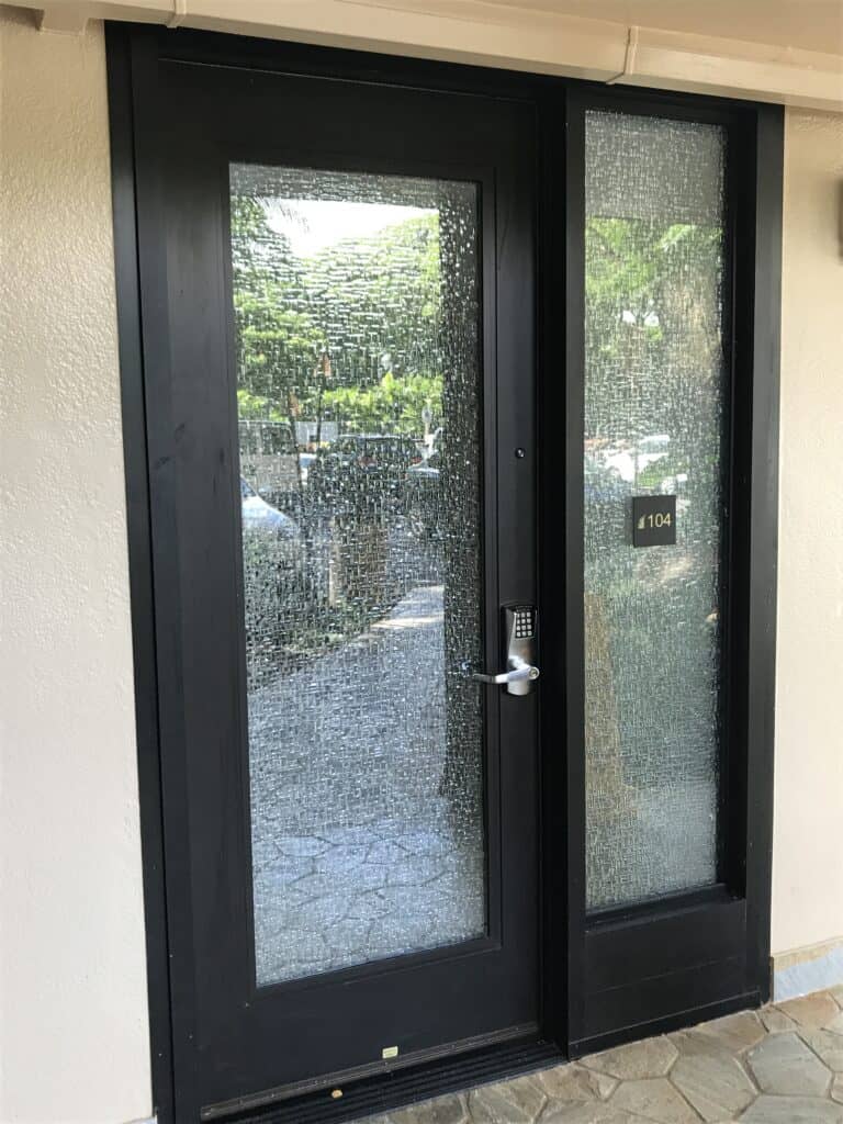 A black door with patterned glass.