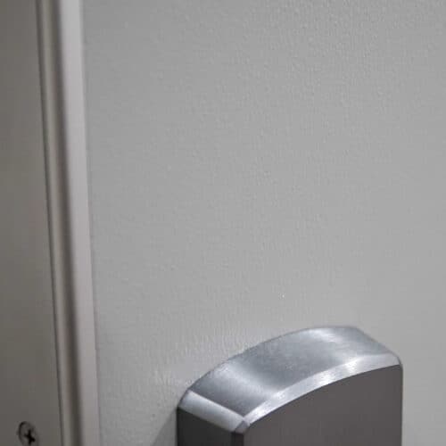 A close up of a stainless steel HMR-FRP door handle.