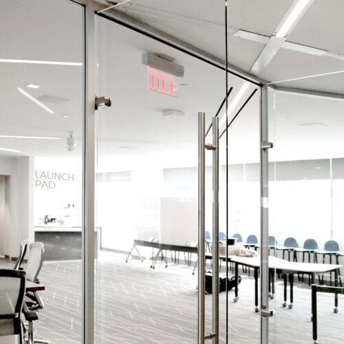 Glass-walled conference room with modern furniture and Interior Aluminum Framing by LiteSpace, an 