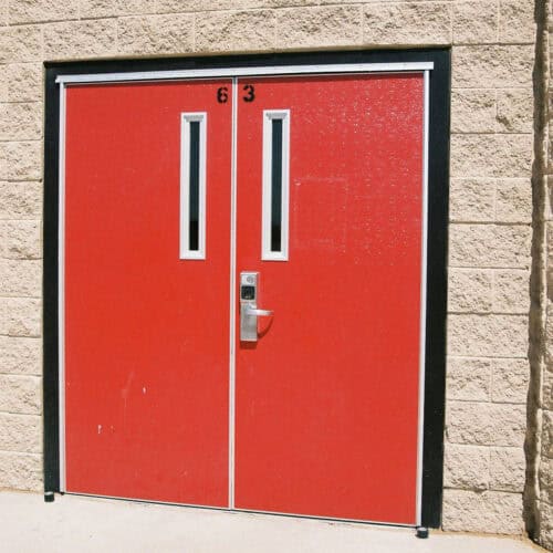 Two Pebble Grain Hybrid FRP red double doors with narrow rectangular windows, labeled 