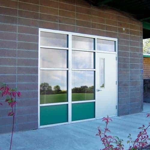 A school building with a green door.