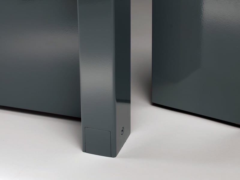 A close up of a grey cabinet with a metal base.