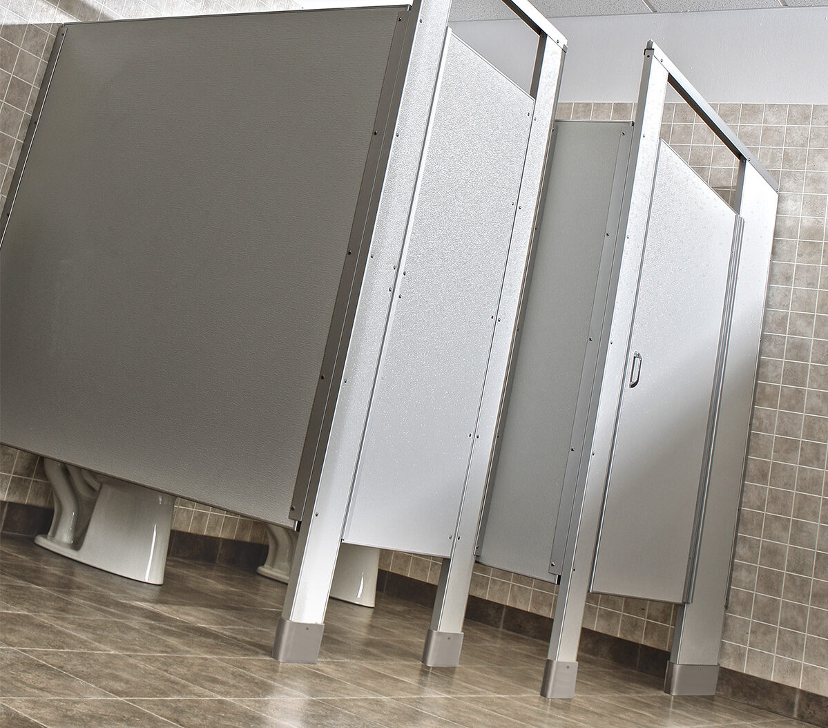 A group of interior stalls made to order in a public restroom.