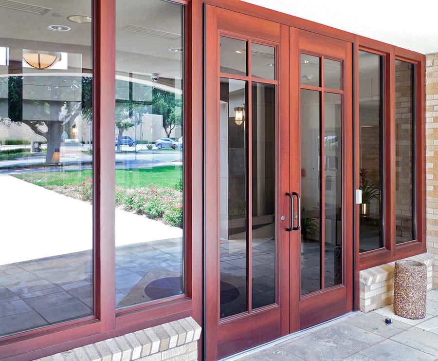 A branded front door with a glass panel and a wooden frame, made to order.