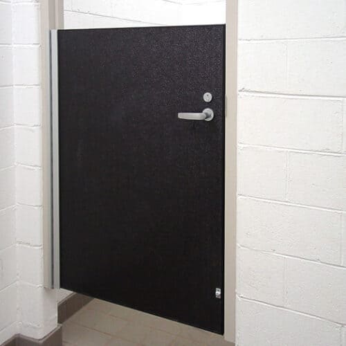 A black FRP Aluminum stall door in a bathroom.