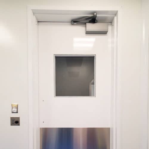 A white door in a room with a glass door.