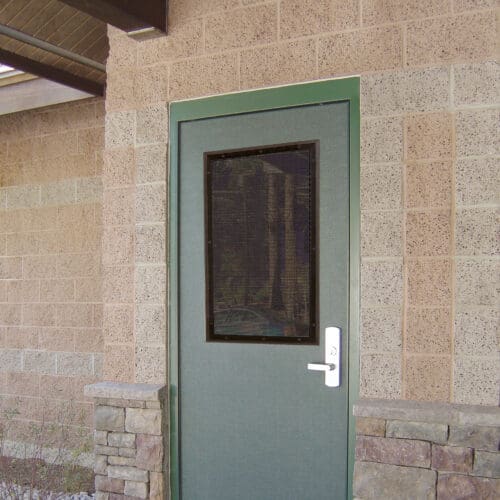 A green door with a window on it.