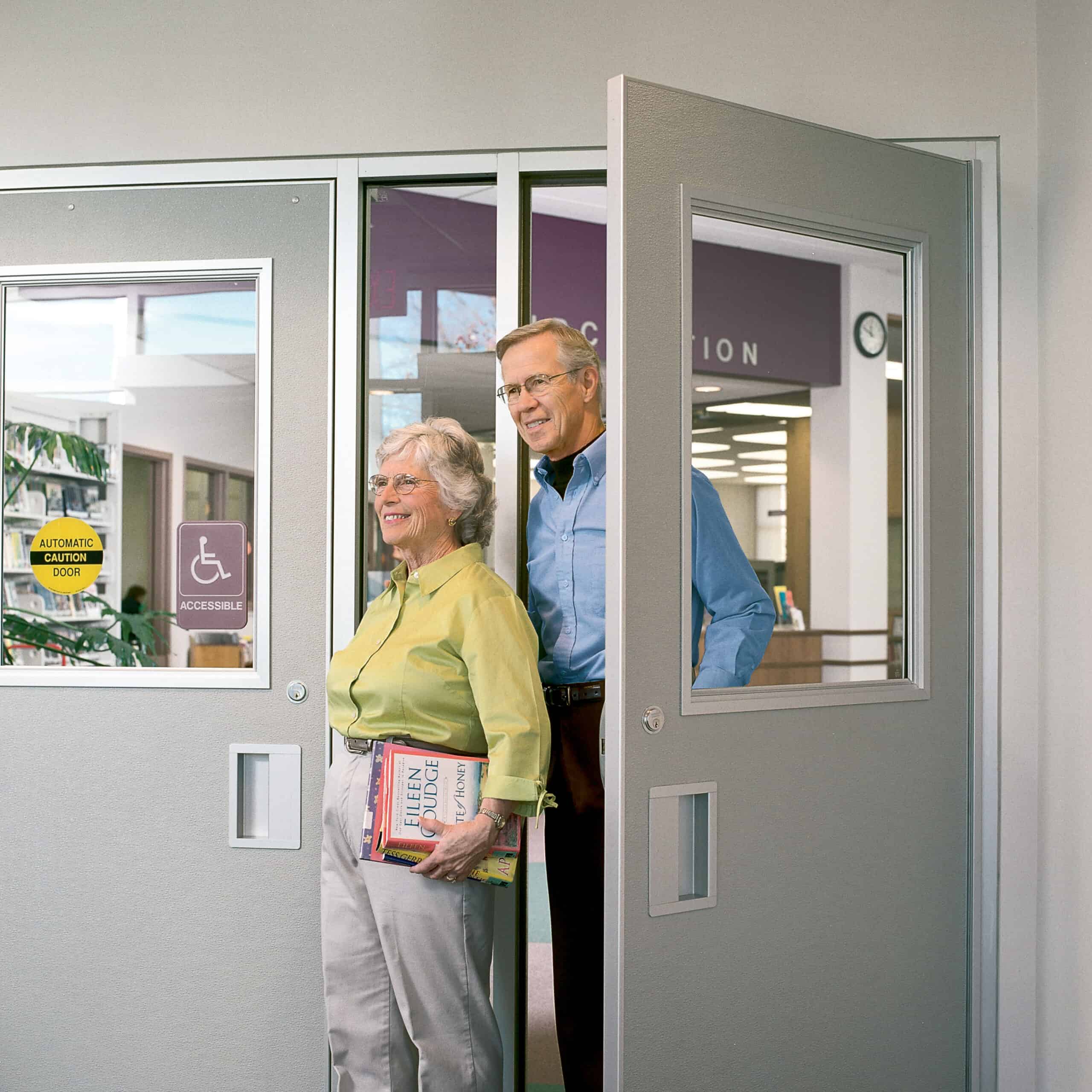 A man and a woman standing in front of a door.