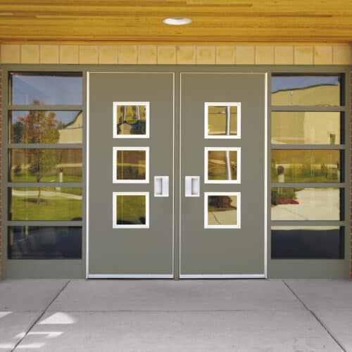 A school building with a glass front door.