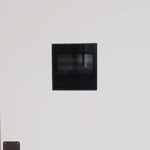 A black square on the wall of a room.
