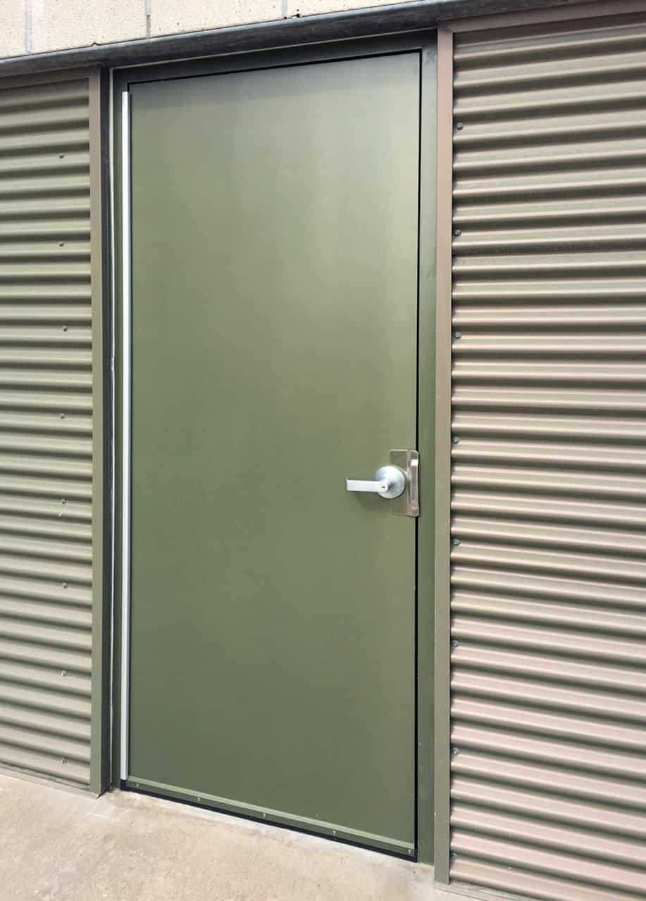 A green door with a metal frame.