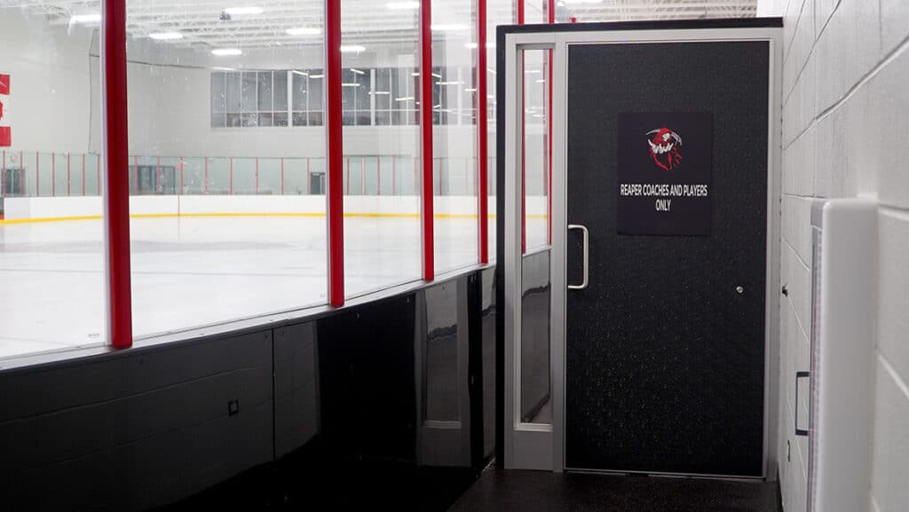 Door adjacent to hockey rink glass. 