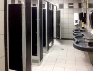 A restroom with multiple stalls and sinks.