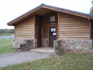 A wooden building on a grassy area.