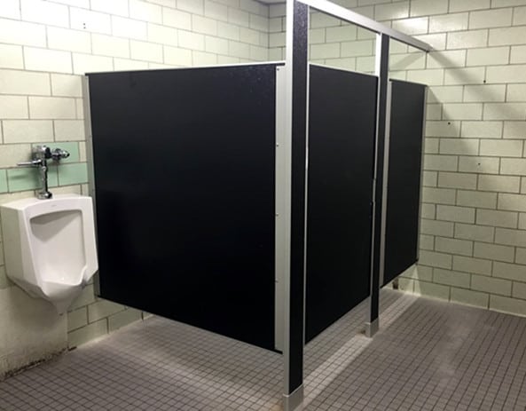 A bathroom with two stalls and a sink equipped with Try Me: Special-Lite Bathroom Partitions.