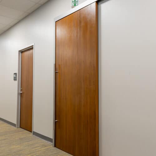 A hallway with a wooden door.