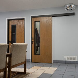 A room with two chairs and a door.