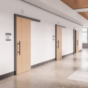 A hallway with wooden doors and white walls.