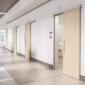 A hallway with sliding doors and white walls.