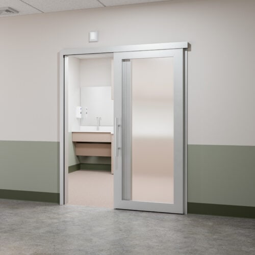 A hospital room with a sliding glass door.