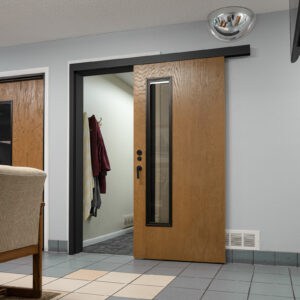 A room with a wooden door and a chair.