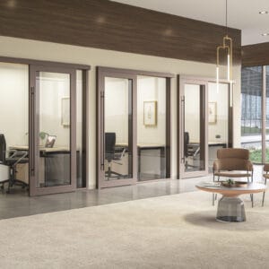 A modern office with glass doors and chairs.