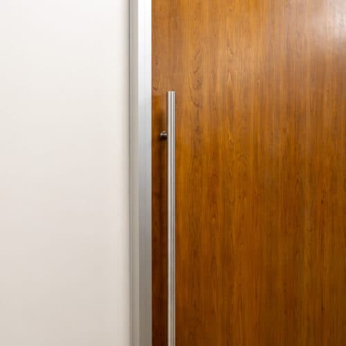 A wooden door with a metal handle.