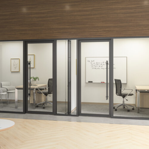 Office hallway with three glass-walled rooms containing desks, chairs, and whiteboards. The nearest room has a drawing on the wall, while the farthest has notes written on its whiteboard. The glass partition walls with enhanced privacy ensure confidentiality in each workspace.