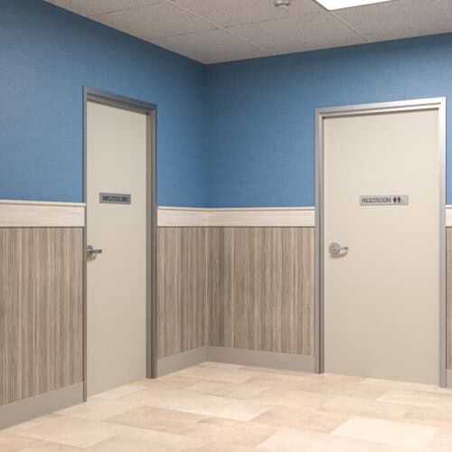 Two closed doors in a hallway: one marked 